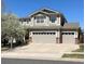 Charming two-story home featuring a well-manicured lawn, a three-car garage and beautiful mature landscaping at 15901 E 106Th Way, Commerce City, CO 80022