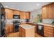 Functional kitchen featuring modern appliances, a center island, and ample cabinet space at 15901 E 106Th Way, Commerce City, CO 80022