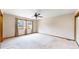 Neutral bedroom with a ceiling fan, large window and plush carpeting at 23 Carla Way, Broomfield, CO 80020