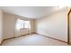 Well-lit bedroom with a large window, sheer curtains, and carpeting at 23 Carla Way, Broomfield, CO 80020