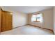 Bright bedroom featuring a large window, sheer curtains, and closet at 23 Carla Way, Broomfield, CO 80020