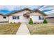 Charming single-story home with a walkway leading to the front door and manicured shrubs at 23 Carla Way, Broomfield, CO 80020