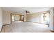 Bright and airy living room with neutral carpeting, ceiling fan, and seamless flow to other spaces at 23 Carla Way, Broomfield, CO 80020