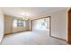 Bright living room featuring neutral carpet, an elegant chandelier, and many windows at 23 Carla Way, Broomfield, CO 80020