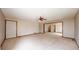 Expansive living room with neutral carpeting, ceiling fan, and an open flow to other rooms at 23 Carla Way, Broomfield, CO 80020