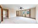 Large main bedroom with neutral carpet, natural light, and a view to the ensuite bathroom at 23 Carla Way, Broomfield, CO 80020