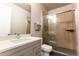Bright bathroom features modern vanity, shower with glass door, and neutral tile at 1152 S Ogden St, Denver, CO 80210