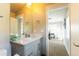 Bathroom featuring a gray vanity, large mirror, and view into the office area at 1152 S Ogden St, Denver, CO 80210