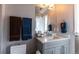 Bathroom features a modern vanity, large mirror, and towel racks at 1152 S Ogden St, Denver, CO 80210