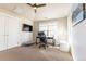 Office space with ceiling fan includes a desk, television, and natural lighting at 1152 S Ogden St, Denver, CO 80210