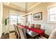 Bright and airy dining room with ample seating, modern light fixture, and large windows for natural light at 1152 S Ogden St, Denver, CO 80210
