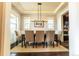 Elegant dining room featuring stylish chandelier, large windows, and ample seating for entertaining at 1152 S Ogden St, Denver, CO 80210