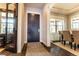 Welcoming entryway features a dark wood door, hardwood floors, and views into the dining room at 1152 S Ogden St, Denver, CO 80210