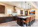 Spacious kitchen with dark wood cabinets, a center island, and modern appliances at 1152 S Ogden St, Denver, CO 80210