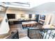 A view of a modern kitchen overlooking the living room featuring an island with bar seating at 1152 S Ogden St, Denver, CO 80210