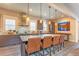 Modern kitchen features a large island with counter seating, stainless steel appliances, and stylish pendant lighting at 1152 S Ogden St, Denver, CO 80210
