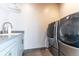 Convenient laundry room with modern washer and dryer and utility sink at 1152 S Ogden St, Denver, CO 80210