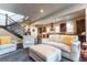 Bright living room with hardwood floors, staircase, and an open layout to the kitchen at 1152 S Ogden St, Denver, CO 80210