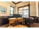 Comfortable home office space featuring a warm wood desk, natural light, and a view to the front porch at 1152 S Ogden St, Denver, CO 80210