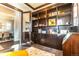 Spacious home office showcasing custom dark wood built-in shelving and cabinets for ample storage at 1152 S Ogden St, Denver, CO 80210