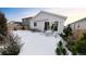 Snowy backyard with patio furniture and a retractable awning at 20 Vista Canyon Dr, Castle Rock, CO 80104