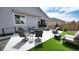 Spacious backyard featuring concrete patio area with outdoor seating, artificial turf, and privacy fencing at 20 Vista Canyon Dr, Castle Rock, CO 80104