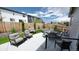 Wide backyard angle showing a concrete patio with outdoor furniture, artificial turf, and a wooden privacy fence at 20 Vista Canyon Dr, Castle Rock, CO 80104
