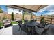 Backyard with extended patio area with shade covering, outdoor seating, fenced for privacy, and grass at 20 Vista Canyon Dr, Castle Rock, CO 80104