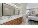 The bathroom has double vanity sinks, and mirror lighting, with walk-in shower access at 20 Vista Canyon Dr, Castle Rock, CO 80104