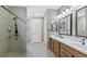 Modern bathroom with double vanity sinks, walk-in shower and neutral tile flooring at 20 Vista Canyon Dr, Castle Rock, CO 80104