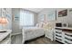 Comfortable bedroom with cozy decor, a white bed frame, and a view of the bright window at 20 Vista Canyon Dr, Castle Rock, CO 80104