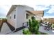 Exterior side view of home showing patio with awning, seating, landscaping, and a concrete walkway at 20 Vista Canyon Dr, Castle Rock, CO 80104