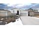 Two-story home with gray garage door and stone accents at 20 Vista Canyon Dr, Castle Rock, CO 80104