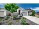 Landscaped front yard with a view of the single story home with a grey door and two-car garage at 20 Vista Canyon Dr, Castle Rock, CO 80104
