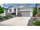 Inviting single-story home with a gray two-car garage door, neat landscaping, and a well-maintained driveway at 20 Vista Canyon Dr, Castle Rock, CO 80104