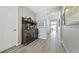 Inviting hallway featuring stylish wood floors and a decorative wooden cabinet with display shelves at 20 Vista Canyon Dr, Castle Rock, CO 80104
