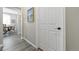 Bright hallway with wood floors, white trim, and artwork leading to dining room at 20 Vista Canyon Dr, Castle Rock, CO 80104