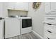 Bright laundry area features white washer/dryer, cabinets, and stylish laundry basket at 20 Vista Canyon Dr, Castle Rock, CO 80104