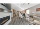 Open-concept living room with a fireplace, flowing into a kitchen with modern appliances and dining area at 20 Vista Canyon Dr, Castle Rock, CO 80104