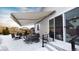 Covered patio with seating area and retractable awning, snow covered at 20 Vista Canyon Dr, Castle Rock, CO 80104