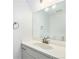Bright bathroom featuring a vanity with a large mirror and modern fixtures at 5145 W 61St Dr # 14, Arvada, CO 80003