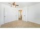 Bedroom featuring neutral carpet, a ceiling fan, and closet with white doors at 5145 W 61St Dr # 14, Arvada, CO 80003