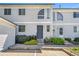 Two story condo featuring light siding, front yard landscaping, and reserved parking at 5145 W 61St Dr # 14, Arvada, CO 80003
