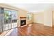 Cozy living room with a fireplace, sliding glass door, and wood-look flooring at 5145 W 61St Dr # 14, Arvada, CO 80003