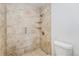 Tiled walk-in shower with built-in shelves and a showerhead at 5145 W 61St Dr # 14, Arvada, CO 80003