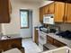 View of kitchen area with white appliances, tile floors and window view at 8181 S Fillmore Cir, Centennial, CO 80122