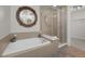Modern bathroom featuring a soaking tub, separate glass-enclosed shower, and elegant finishes at 2001 Lincoln St # 2412, Denver, CO 80202