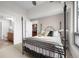 Cozy bedroom features a decorative iron bed frame and doorway leading to the kitchen at 2001 Lincoln St # 2412, Denver, CO 80202