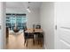 Dining area with a modern table, chairs, and stylish lighting fixture, next to sliding glass doors at 2001 Lincoln St # 2412, Denver, CO 80202