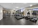 Modern gym featuring treadmills, ellipticals, and strength training machines with city views at 2001 Lincoln St # 2412, Denver, CO 80202